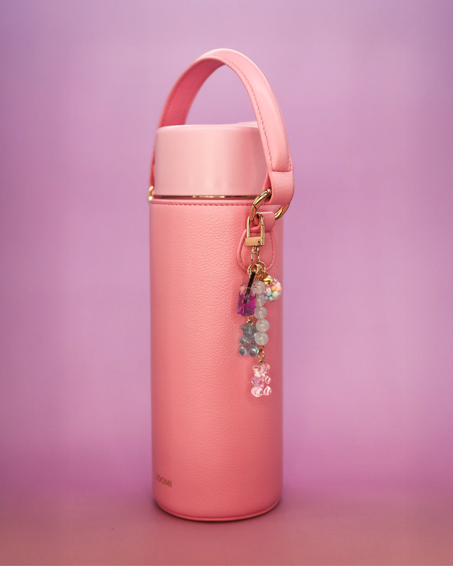 Pink water bottle with strap and gummy bear charm