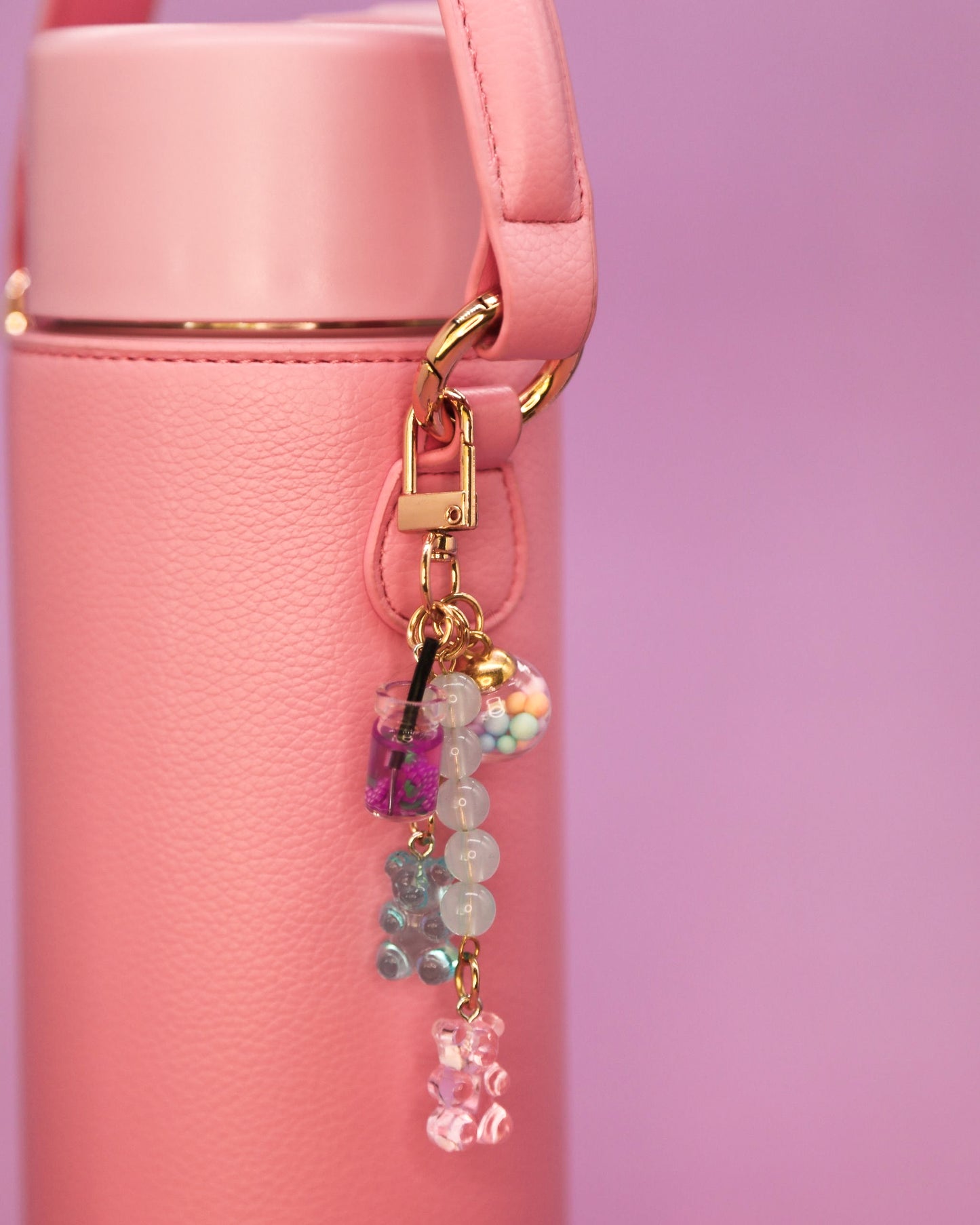 Pink water bottle with gummy bear charm
