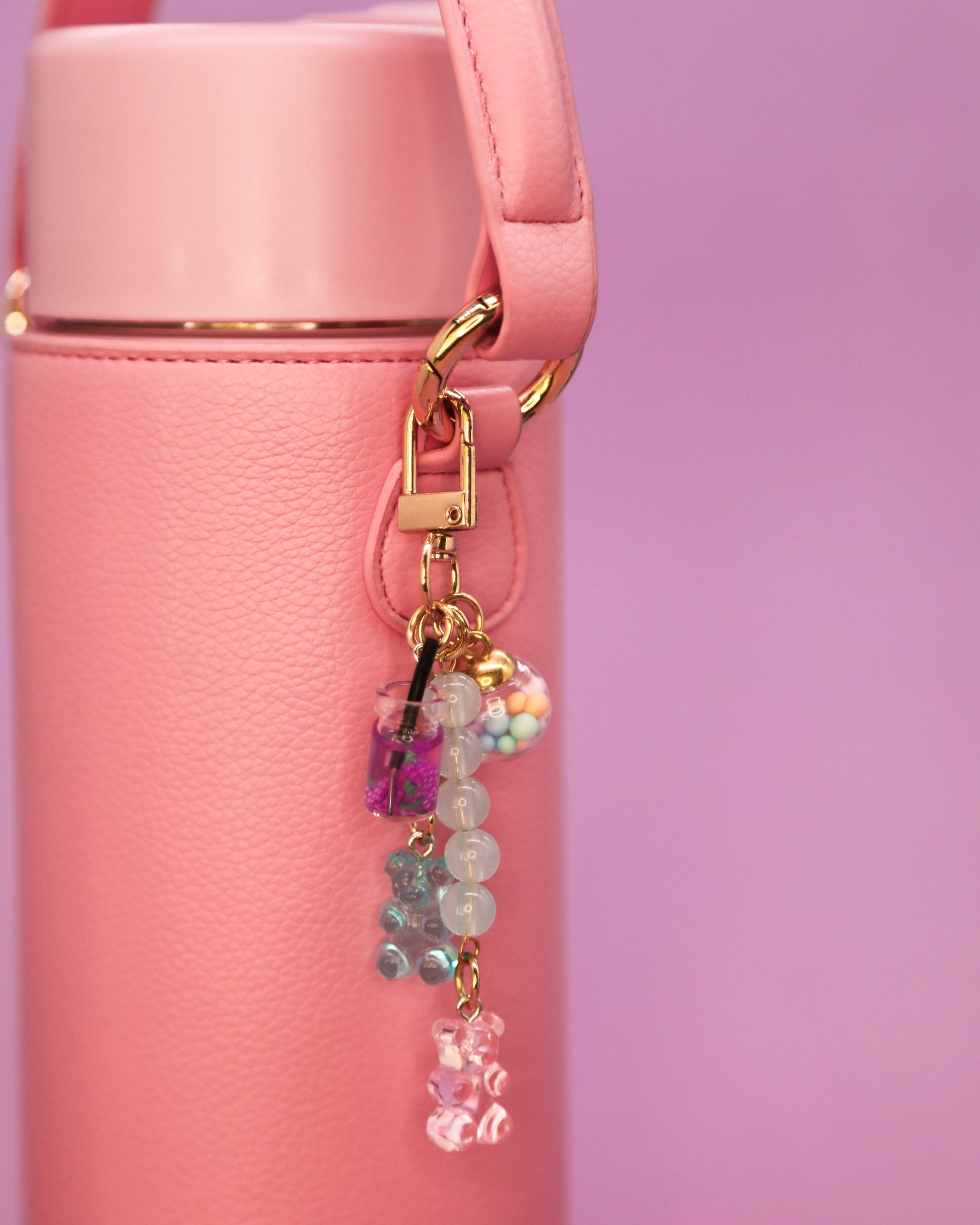 Pink water bottle with gummy bear charm