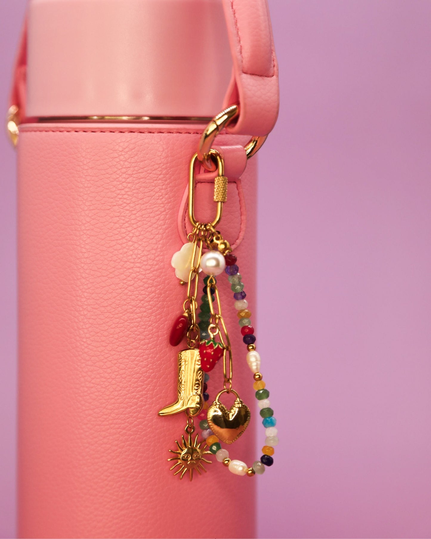 “Cowgirl Confetti charm clipped to a pink Loomi Slip on a bottle