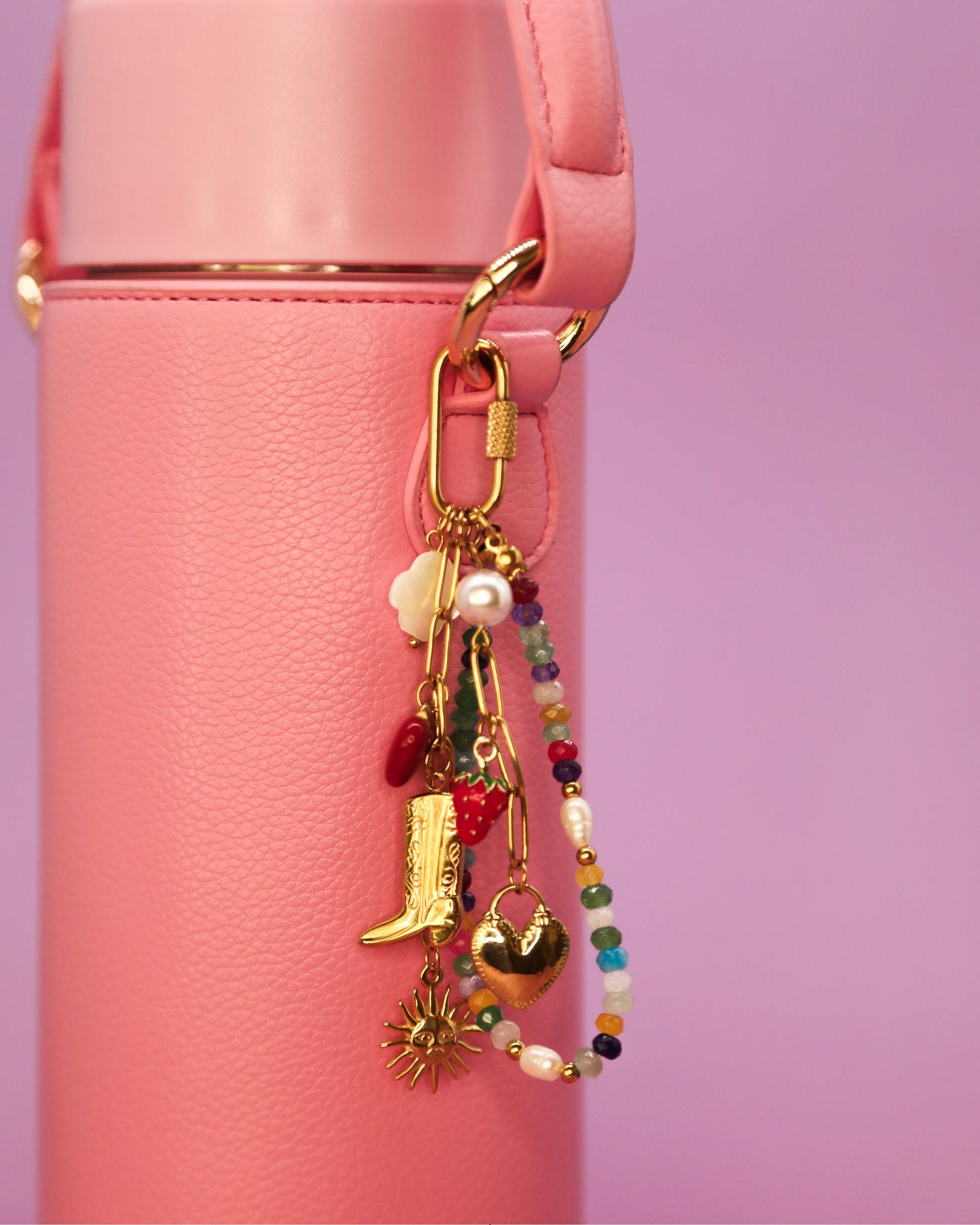 “Cowgirl Confetti charm clipped to a pink Loomi Slip on a bottle