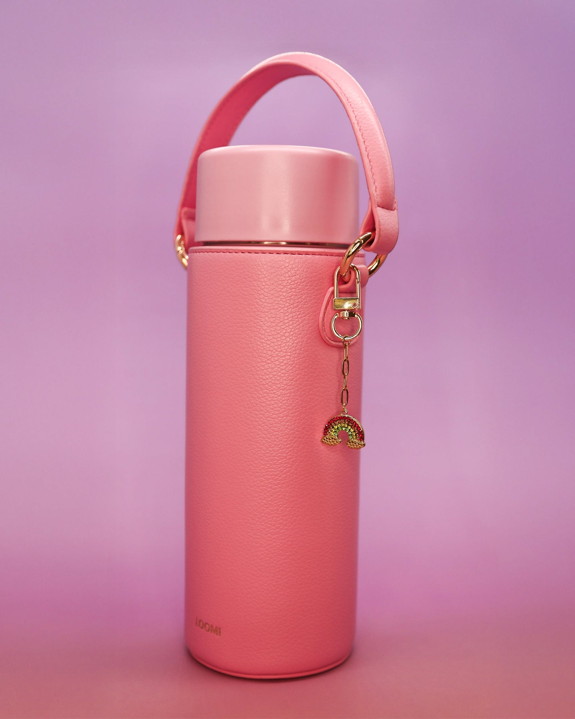 Rainbow water bottle charm clipped to pink Loomi Slip.