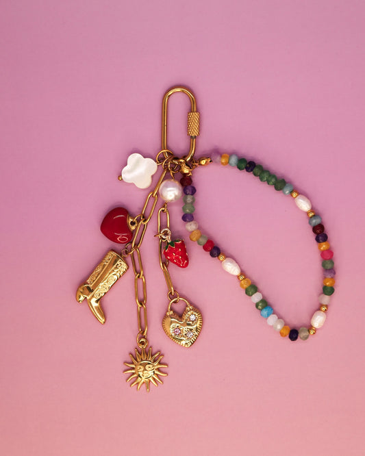 Cowgirl Confetti gold-plated water bottle charm with boot, sun, heart, pearl, strawberry and beaded loop on a screw-gate clasp by Loomi.”